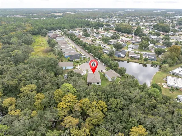 an aerial view of residential houses with outdoor space and swimming pool