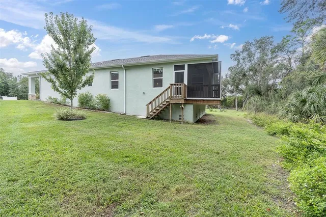 a backyard of a house with table and chairs