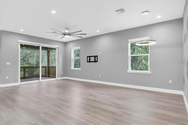 a large kitchen with stainless steel appliances granite countertop a lot of counter space and wooden floor