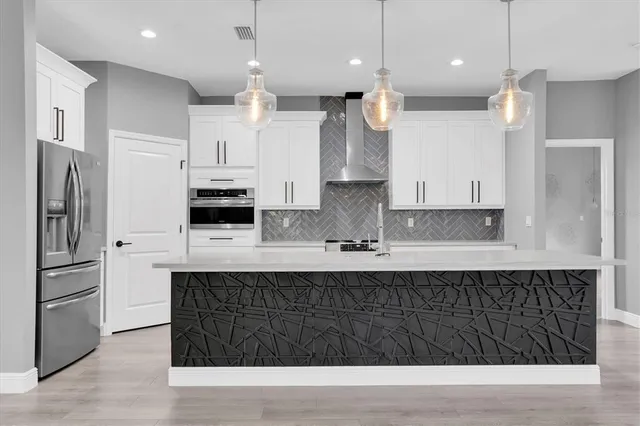 a kitchen with white cabinets and appliances