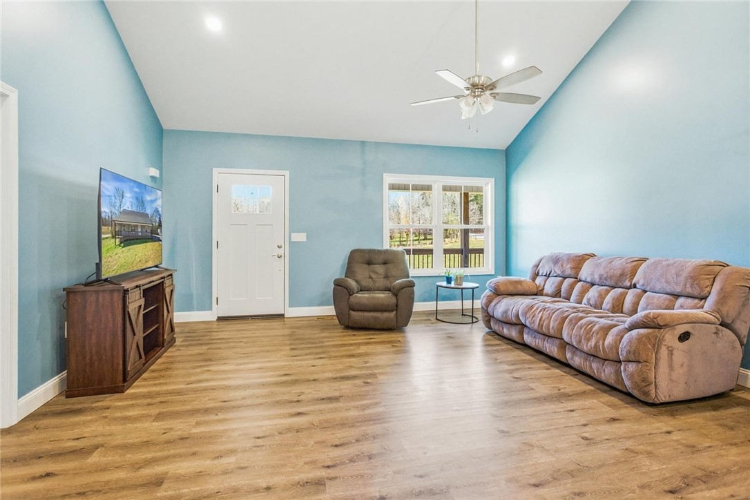 745 Dave Nix Road Seneca, SC 29678 - Photo 9 of 23 A spacious living room welcomes with vaulted ceilings and abundant natural light from broad windows.