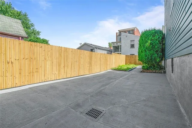 a view of a house with wooden fence and two windows