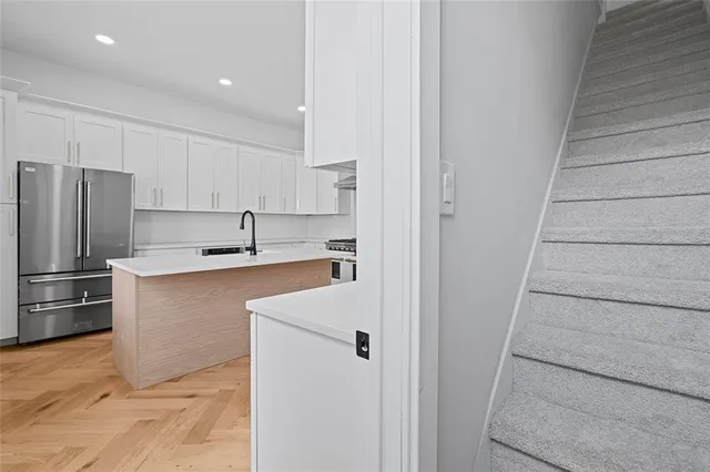 a kitchen with stainless steel appliances a sink stove and refrigerator