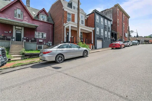 a view of a brick house with wooden floor and windows