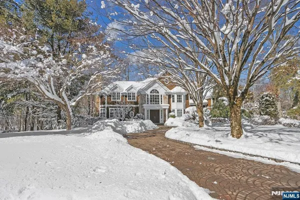 a view of a white house with a snow on the road
