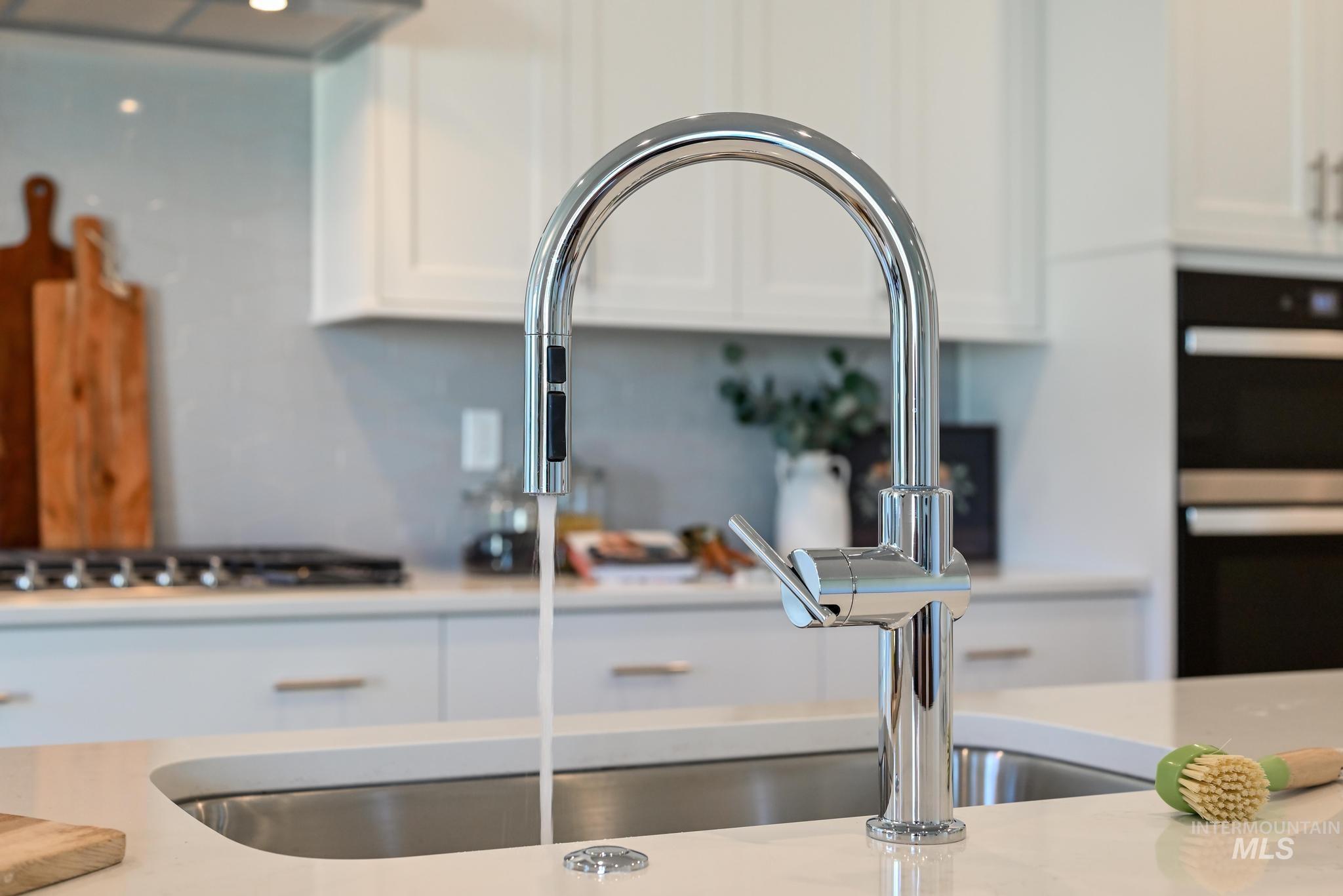 9074 West Moonglade Street Star, ID 83669 - Photo 15 of 40 Stainless steel undermount sink with a chrome gooseneck pull-down faucet