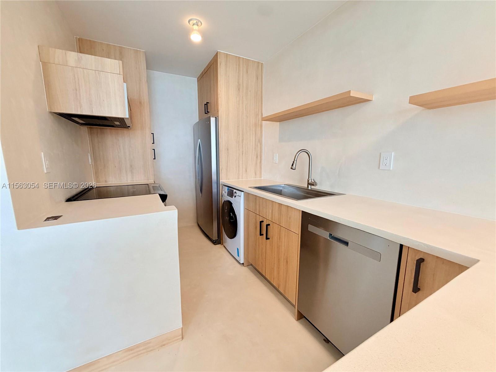 100 Lincoln Road, Unit 1241 Miami Beach, FL 33139 - Photo 4 of 18 a kitchen with a sink a stove and a refrigerator