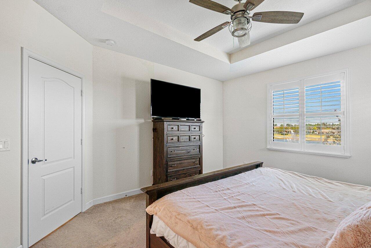 12949 Anthorne Lane Boynton Beach, FL 33436 - Photo 19 of 37 a bedroom with a bed and a television