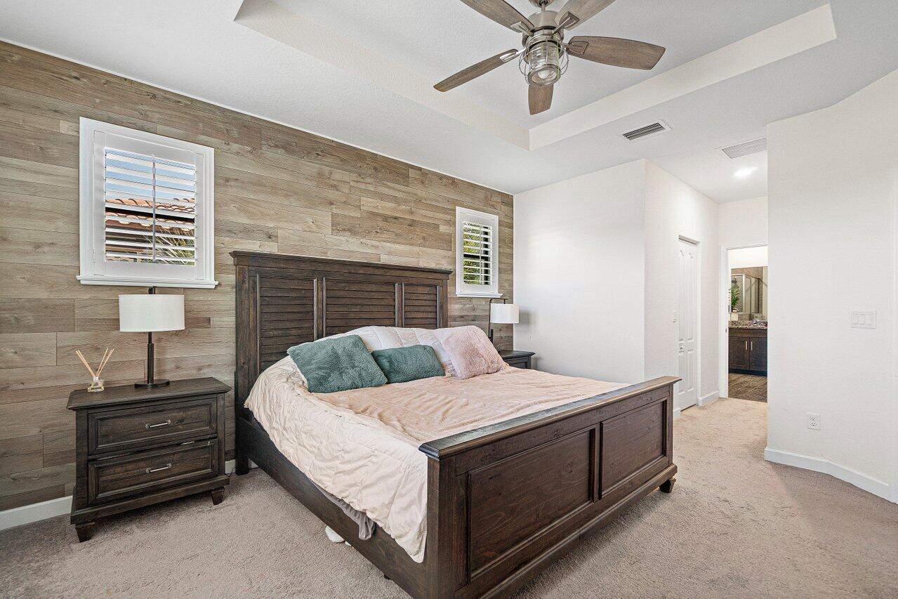 12949 Anthorne Lane Boynton Beach, FL 33436 - Photo 20 of 37 a bedroom with a bed and ceiling fan