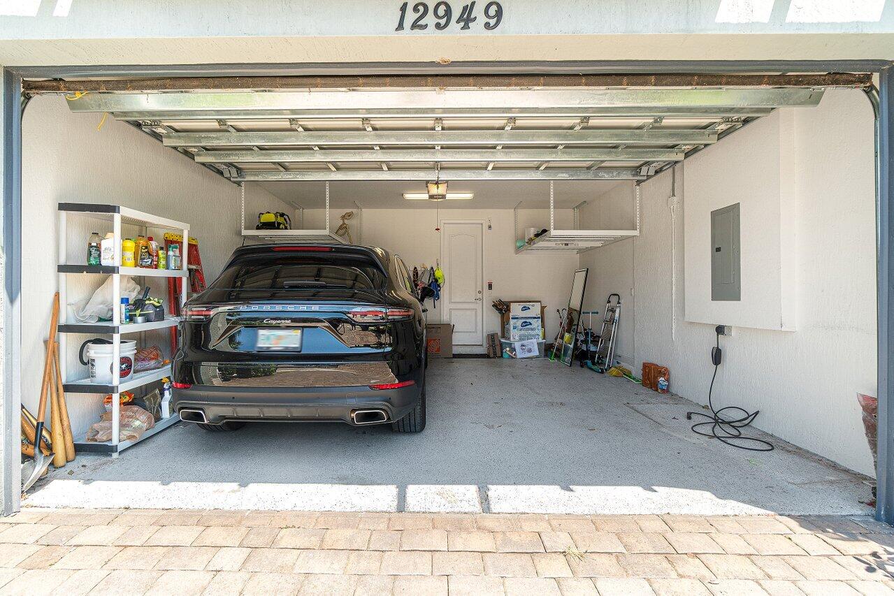 12949 Anthorne Lane Boynton Beach, FL 33436 - Photo 28 of 37 a view of parking garage with cars