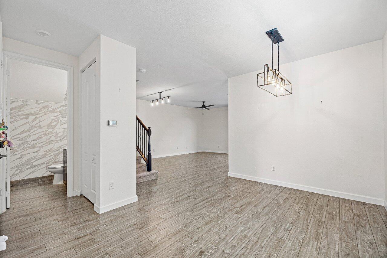 12949 Anthorne Lane Boynton Beach, FL 33436 - Photo 6 of 37 a view of empty room with wooden floor