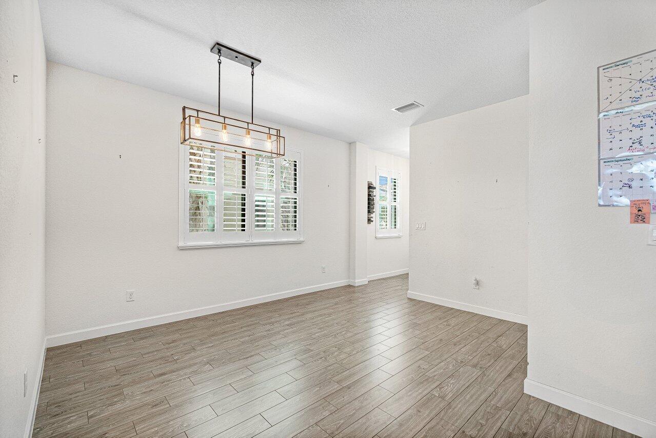 12949 Anthorne Lane Boynton Beach, FL 33436 - Photo 8 of 37 wooden floor in an empty room with a window