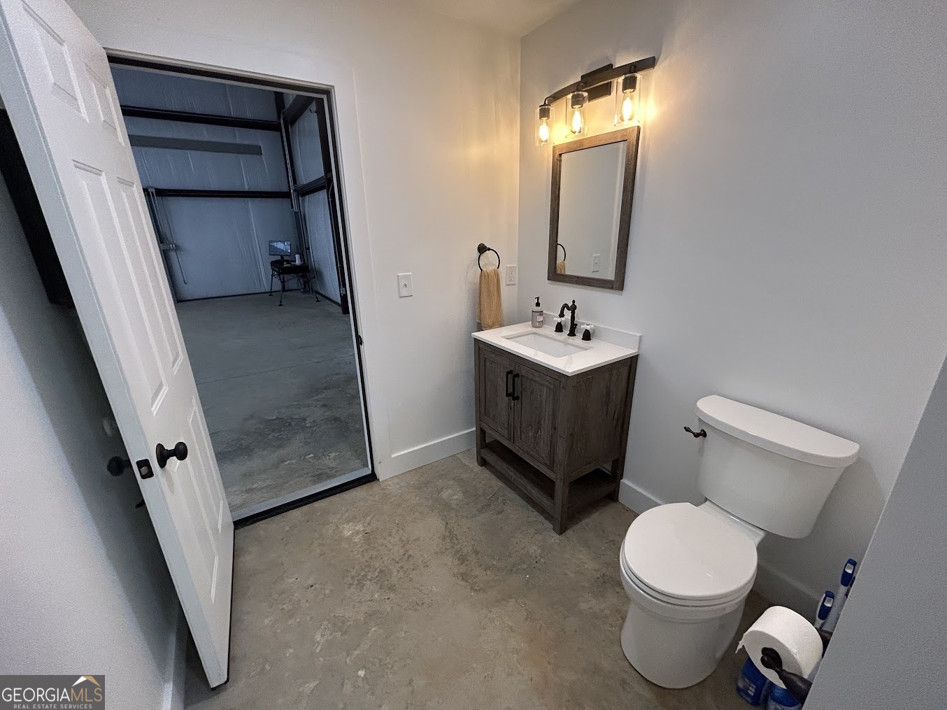 85 Blackjack Mountain Road Bowdon, GA 30108 - Photo 8 of 32 a bathroom with a toilet sink and mirror
