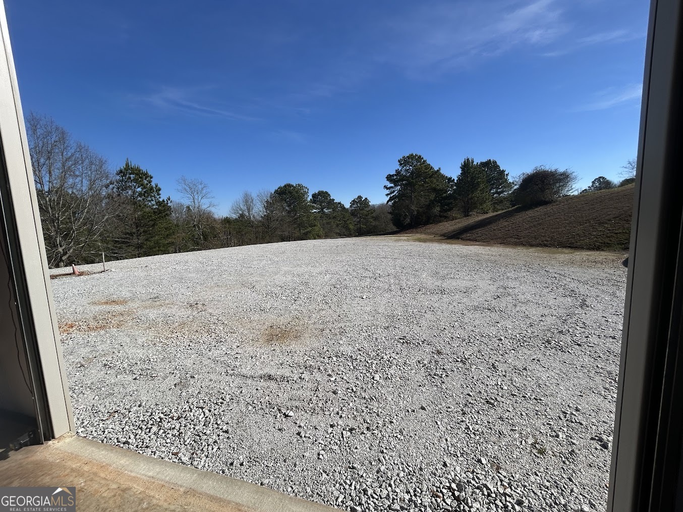 85 Blackjack Mountain Road Bowdon, GA 30108 - Photo 10 of 32 a view of dirt road with a building in the background