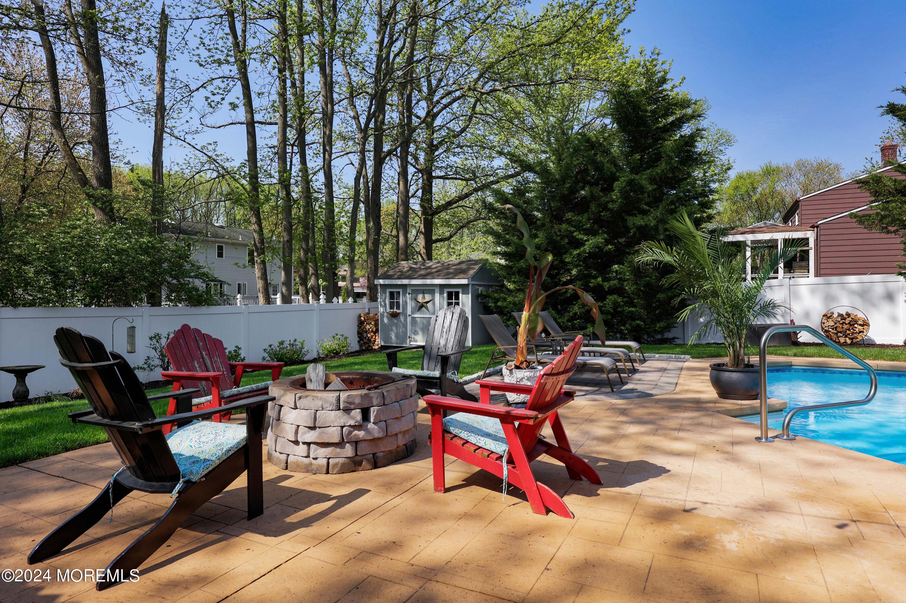 540 E Road Belford, NJ 07718 - Photo 33 of 55 a backyard of a house with fire pit and outdoor seating