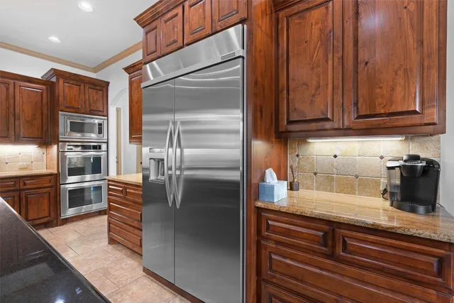 a kitchen with stainless steel appliances a stove a sink dishwasher and a refrigerator