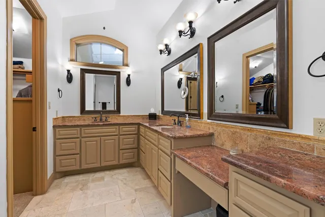 a bedroom with a bed a dresser and a large window