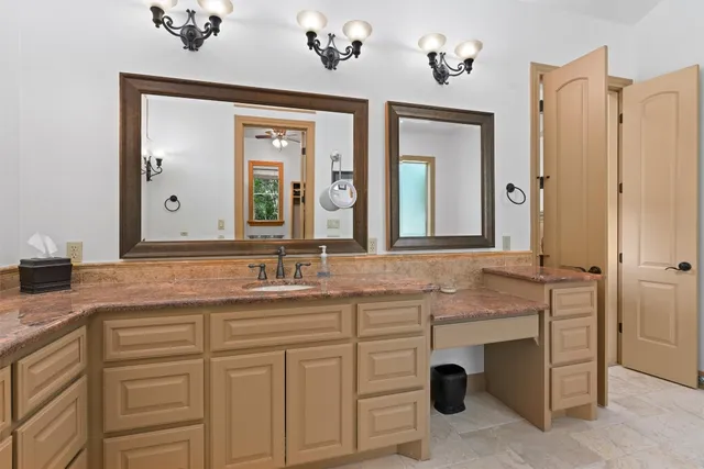 a bathroom with sinks granite vanity and a mirror