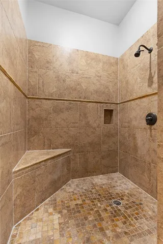a bathroom with a bathtub and shower