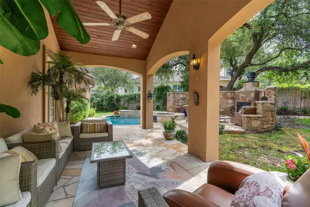 a living room with patio furniture and a potted plant
