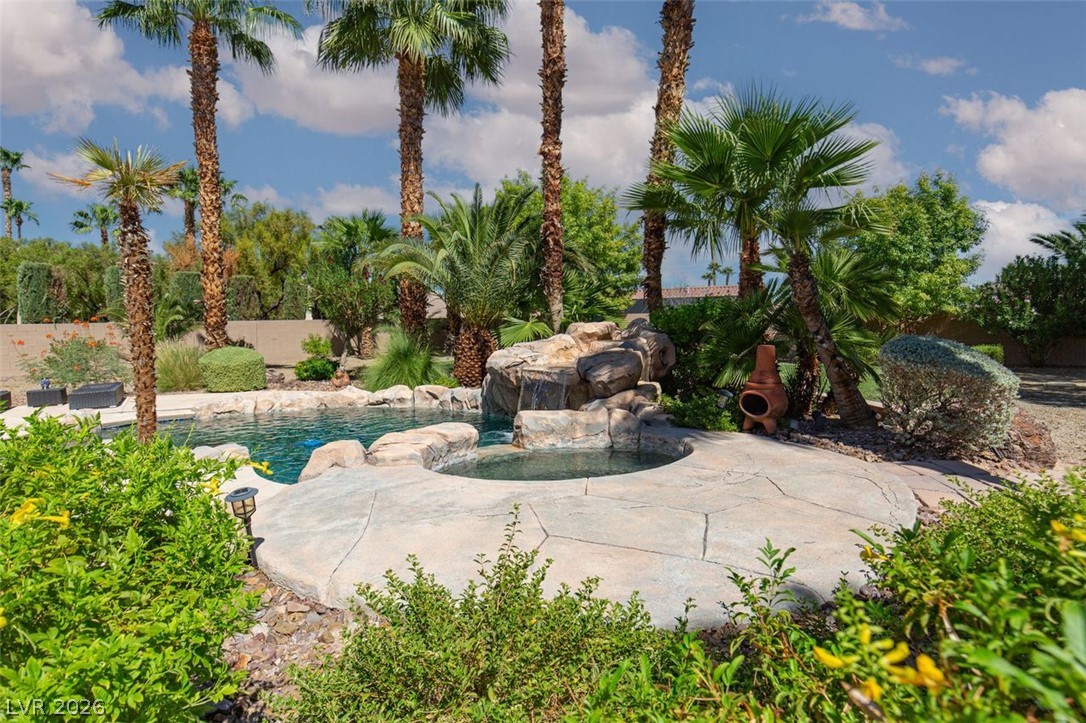 4670 Los Rancheros Avenue Las Vegas, NV 89129 - Photo 41 of 57 Lush tropical plantings and a stone waterfall frame the inviting swimming pool and spa.