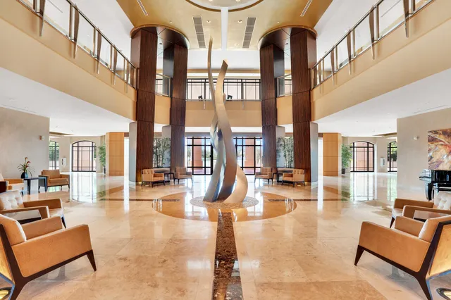 a view of a kitchen with refrigerator and a living room