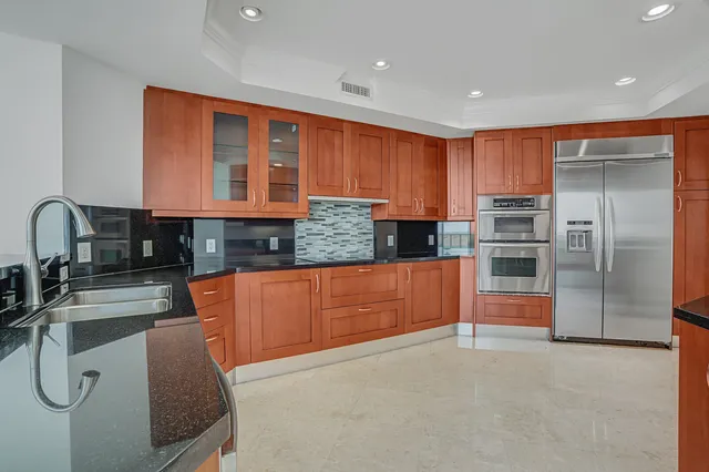 a bathroom with a granite countertop sink mirror and double