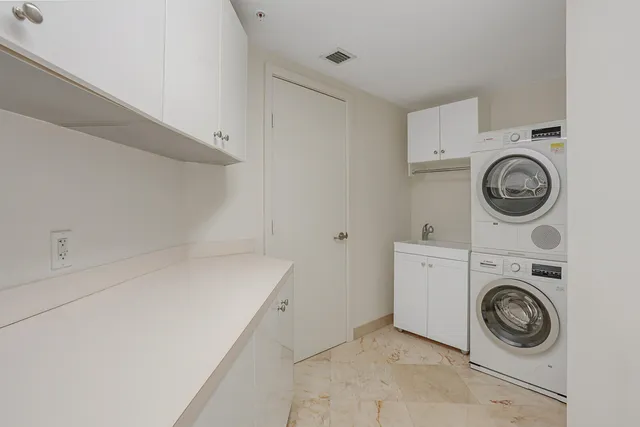 an aerial view of residential houses with outdoor space and lake view