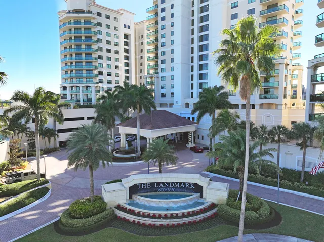 a living room with furniture and floor to ceiling windows
