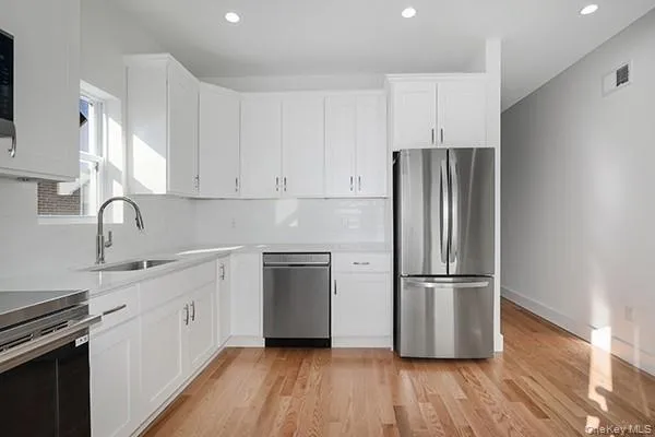 a kitchen with wooden floors and appliances