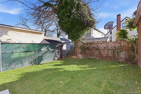 a view of a backyard with a tree