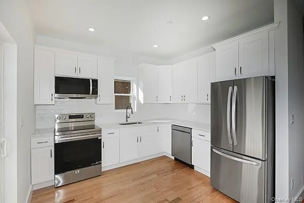 a kitchen with a refrigerator stove and microwave