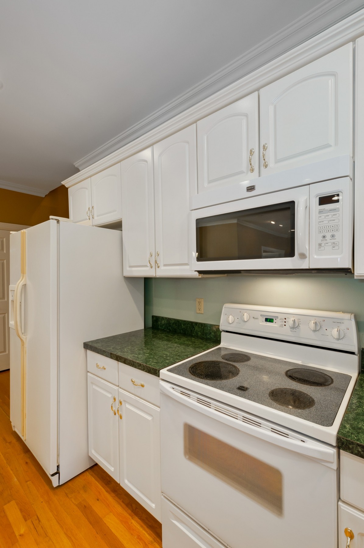 1741 Dean Road Thompson's Station, TN 37179 - Photo 19 of 54 a kitchen with white cabinets and white appliances