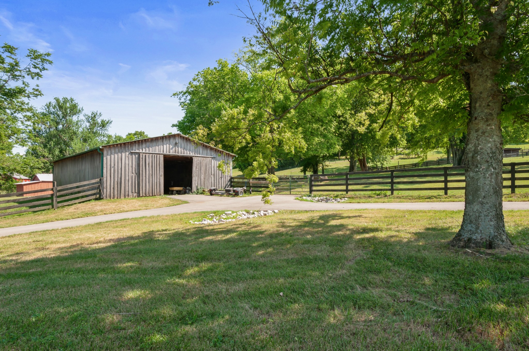 1741 Dean Road Thompson's Station, TN 37179 - Photo 46 of 54 a view of a house with a backyard and a large tree