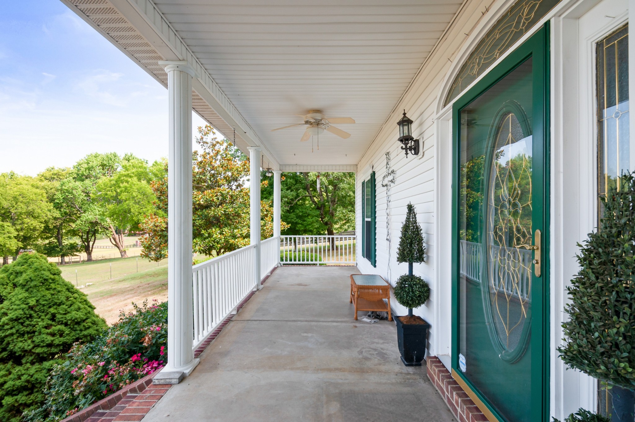 1741 Dean Road Thompson's Station, TN 37179 - Photo 8 of 54 a porch with a table and chairs and potted plants