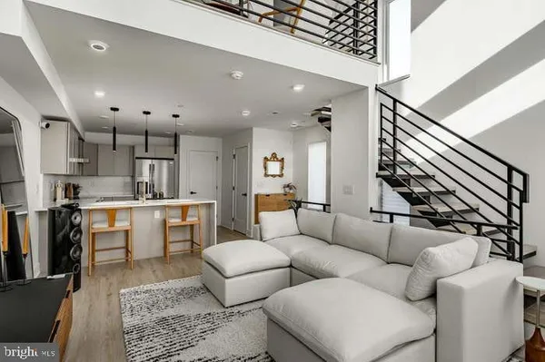 a living room with furniture and kitchen view