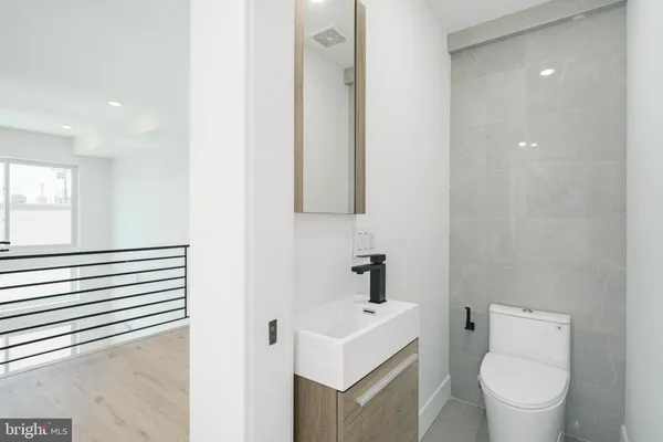 a white toilet sitting next to a bathroom sink