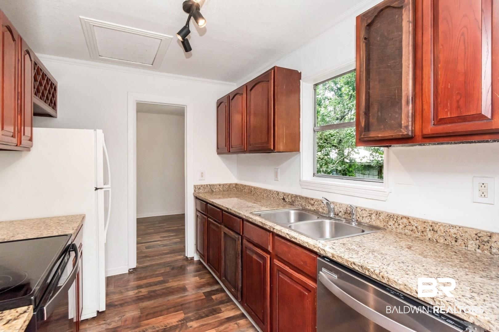2905A McFarland Road, Unit F Mobile, AL 36695 - Photo 9 of 29 Kitchen featuring wood-finish flooring, granite-style countertops, wood cabinetry, a double basin stainless steel sink, and a built-in dishwasher