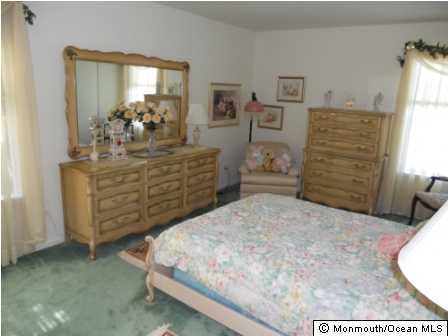 25 Hedgewood Road Howell, NJ 07731 - Photo 3 of 3 a bedroom with a bed and furniture