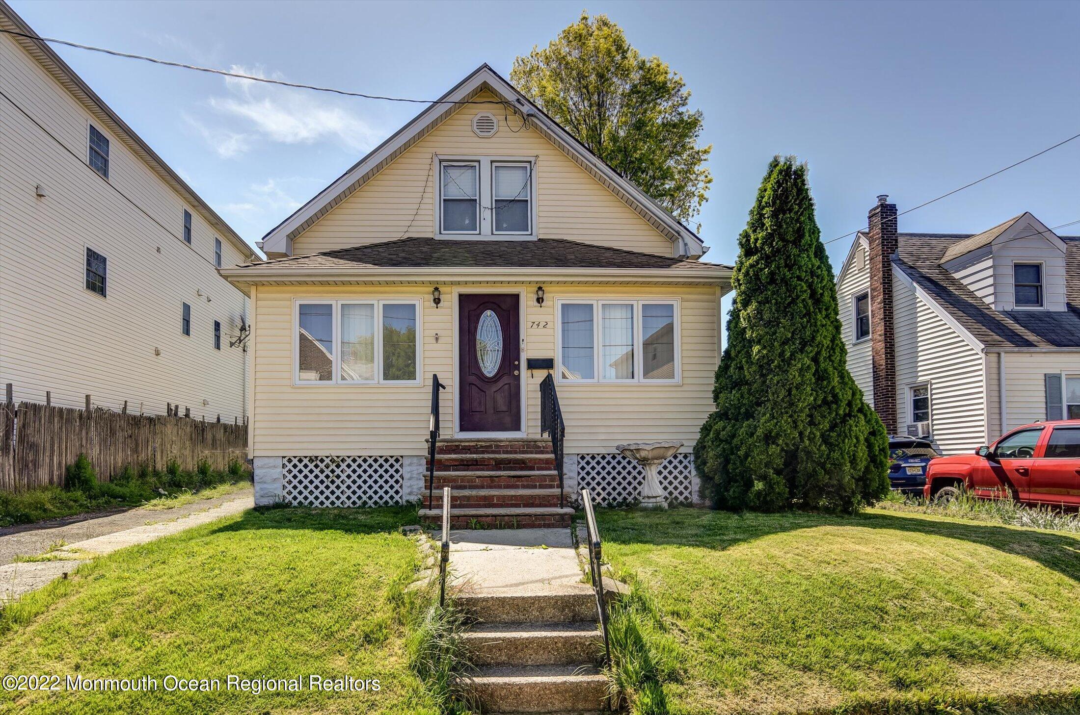a front view of a house with a yard