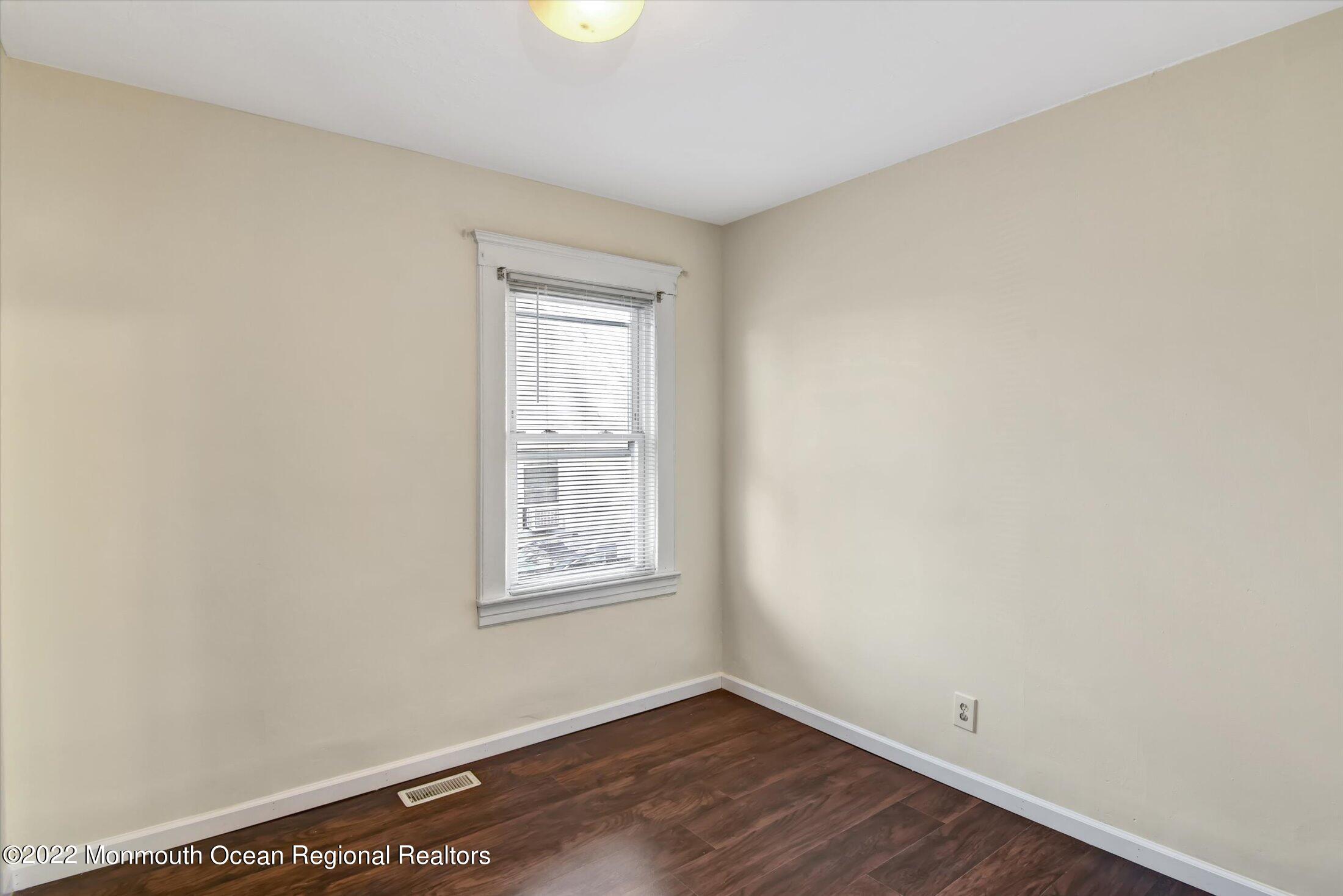 742 Old Road Elizabeth, NJ 07202 - Photo 13 of 25 an empty room with wooden floor and windows