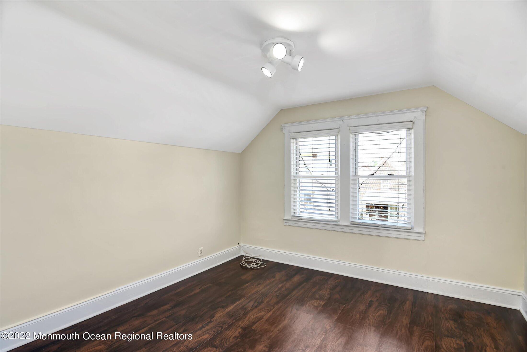 742 Old Road Elizabeth, NJ 07202 - Photo 17 of 25 an empty room with wooden floor and windows