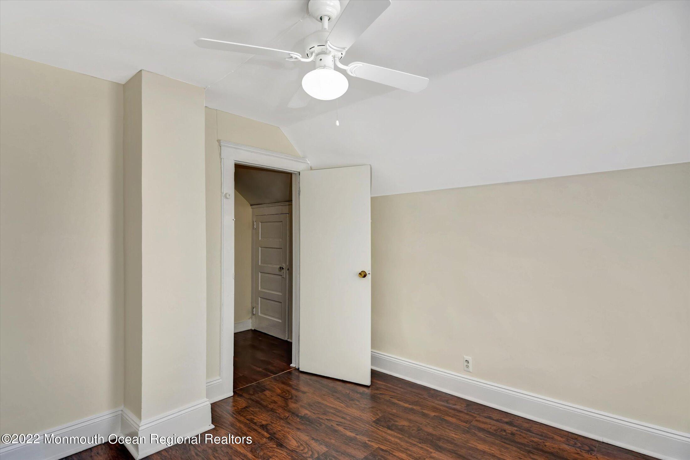 742 Old Road Elizabeth, NJ 07202 - Photo 20 of 25 an empty room with wooden floor and ceiling fan