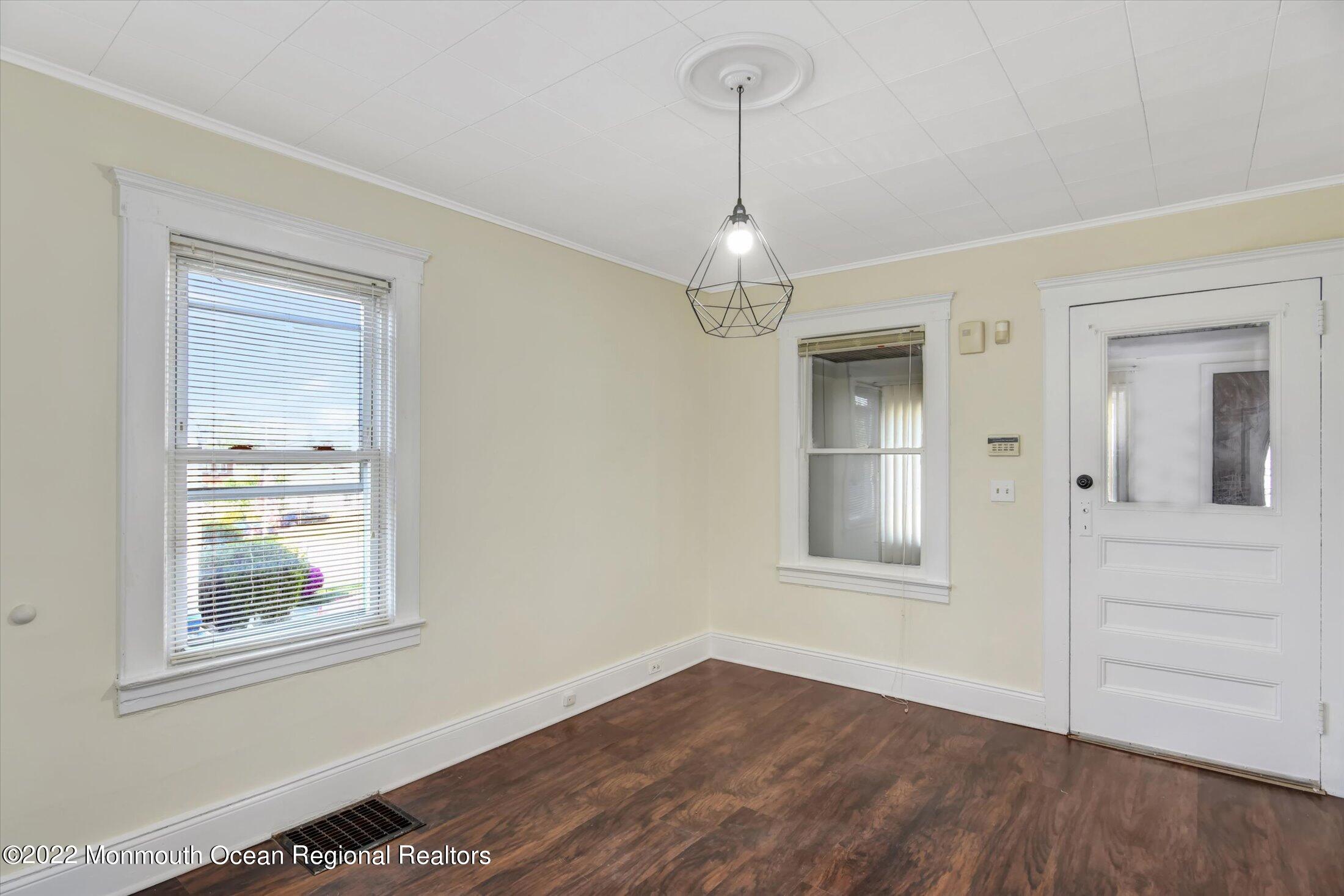 742 Old Road Elizabeth, NJ 07202 - Photo 4 of 25 a view of empty room with wooden floor and window
