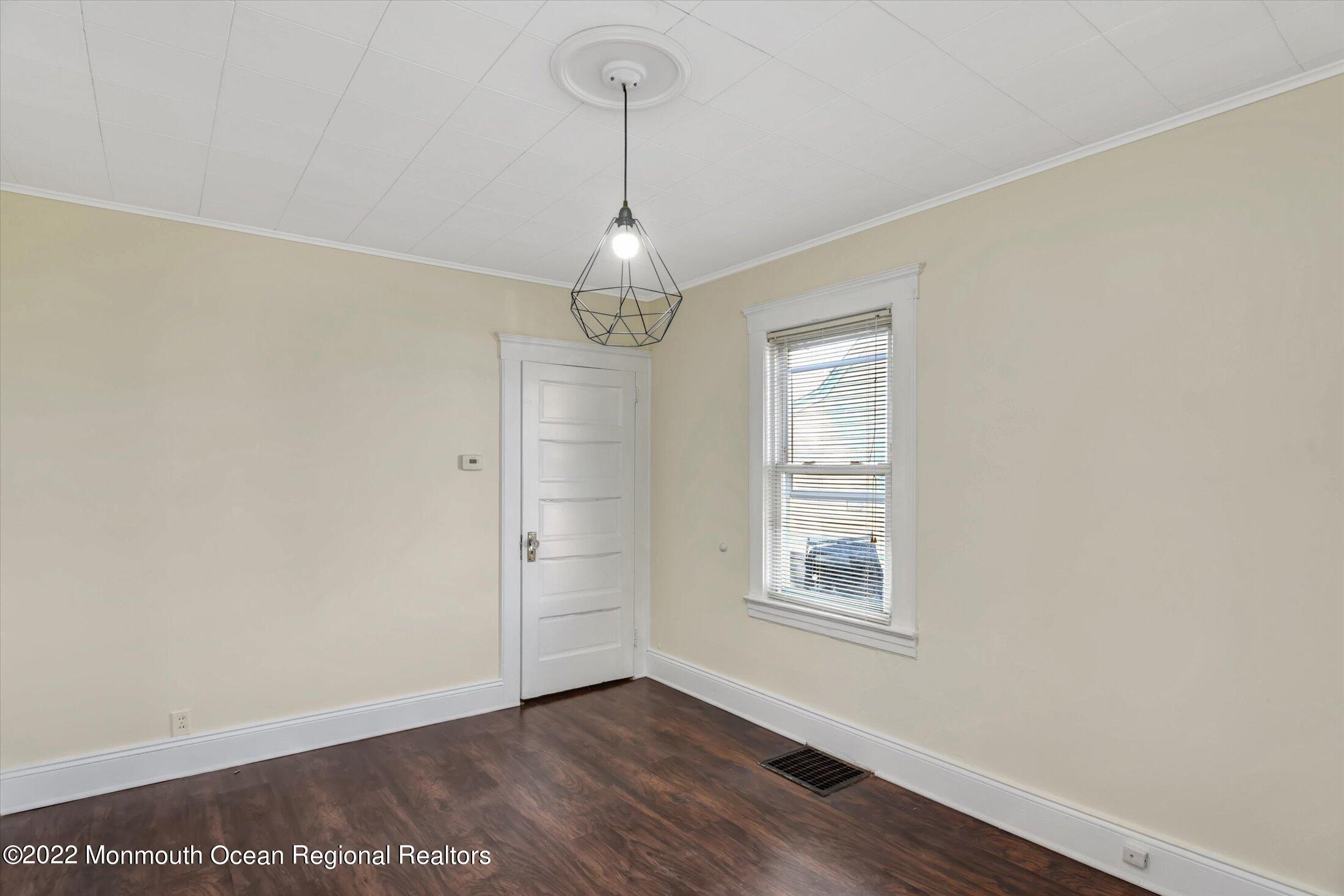 742 Old Road Elizabeth, NJ 07202 - Photo 5 of 25 a view of an empty room with window and wooden floor