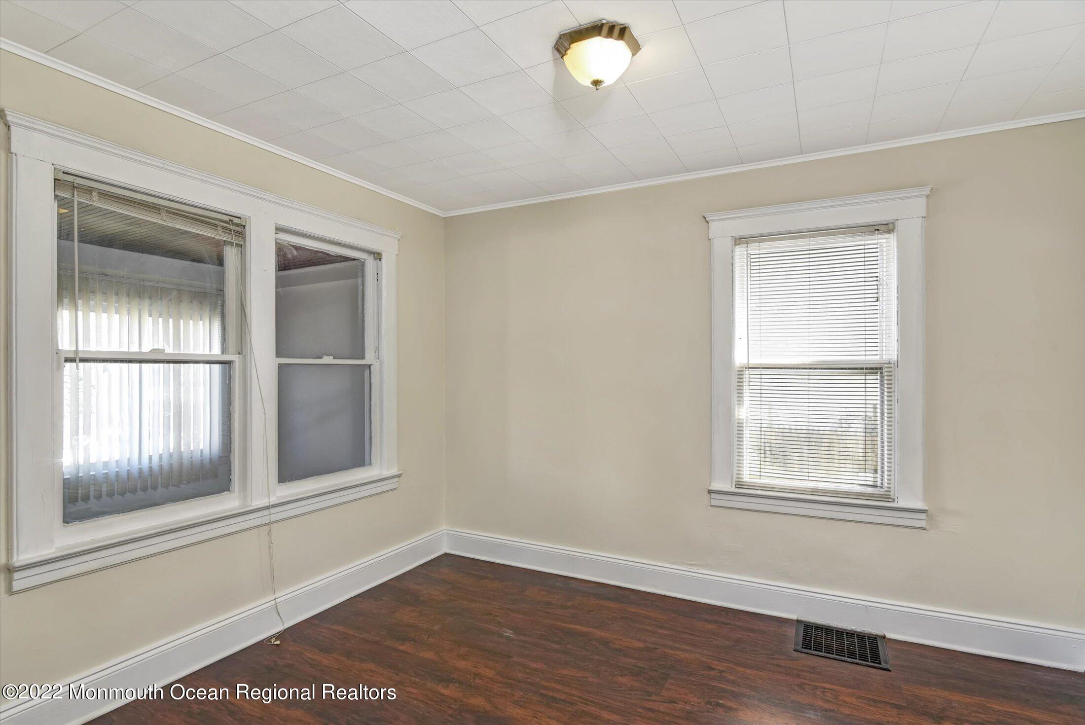 742 Old Road Elizabeth, NJ 07202 - Photo 6 of 25 a view of an empty room with wooden floor and a window