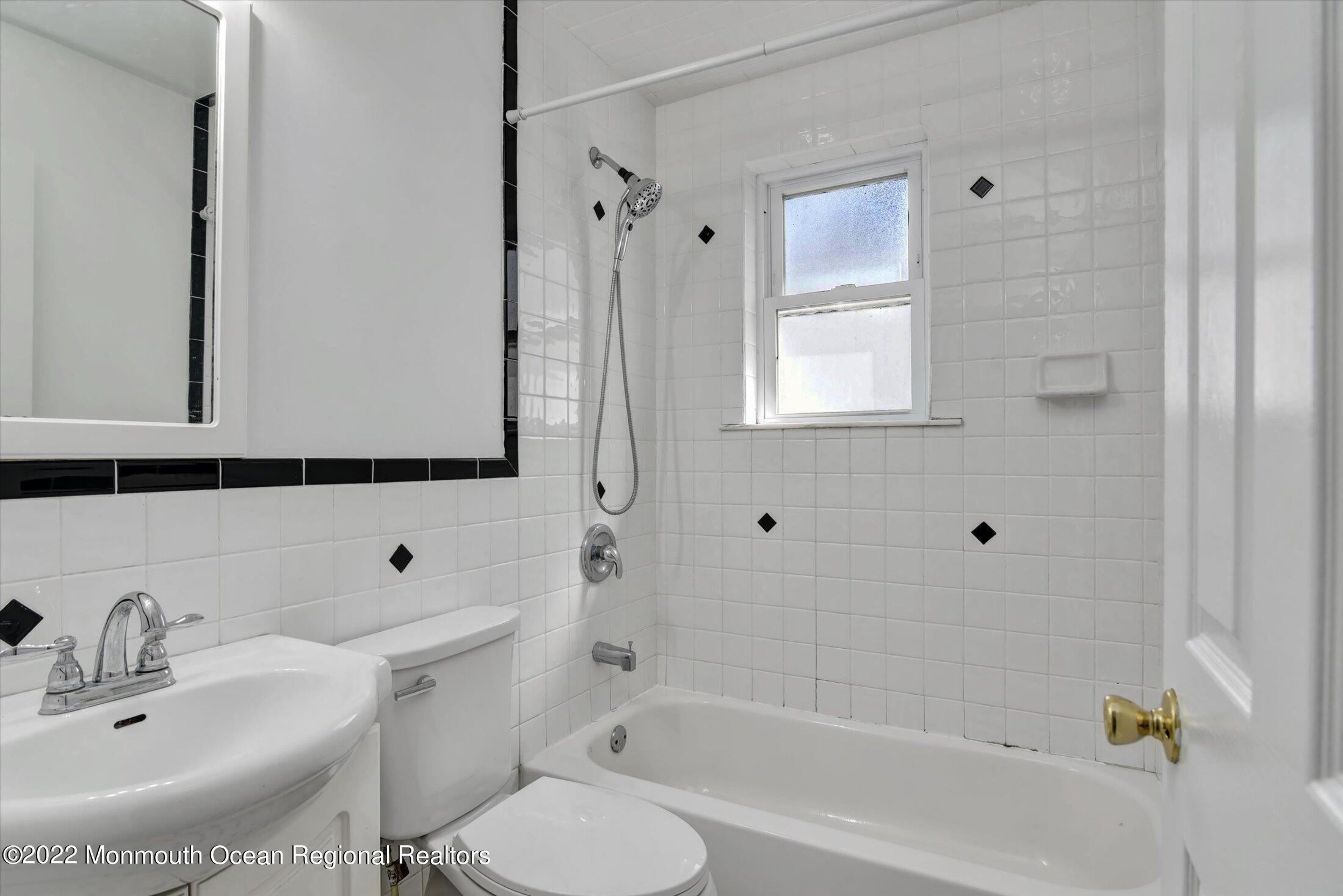 742 Old Road Elizabeth, NJ 07202 - Photo 8 of 25 a bathroom with a bathtub shower sink and a toilet