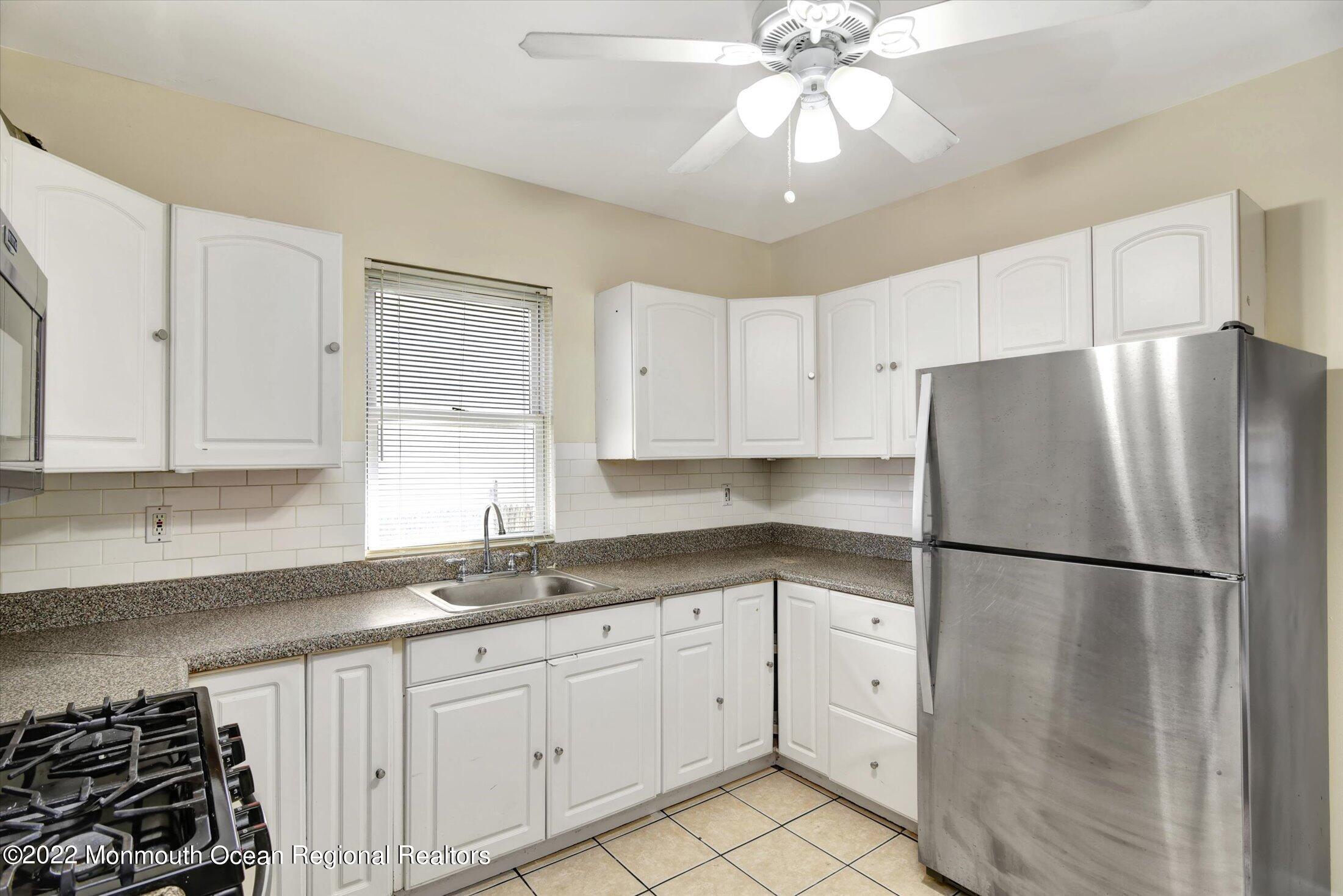 742 Old Road Elizabeth, NJ 07202 - Photo 9 of 25 a kitchen with a refrigerator a sink and cabinets