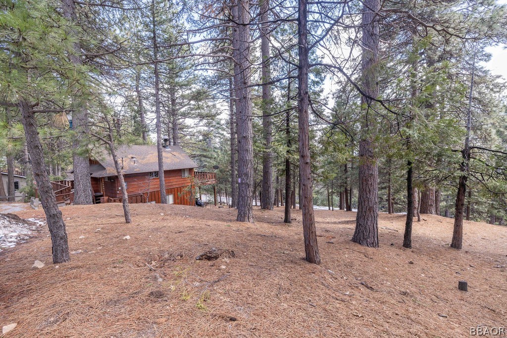 0 Circle View Drive Running Springs, CA 92382 - Photo 2 of 6 a house with trees in front of it