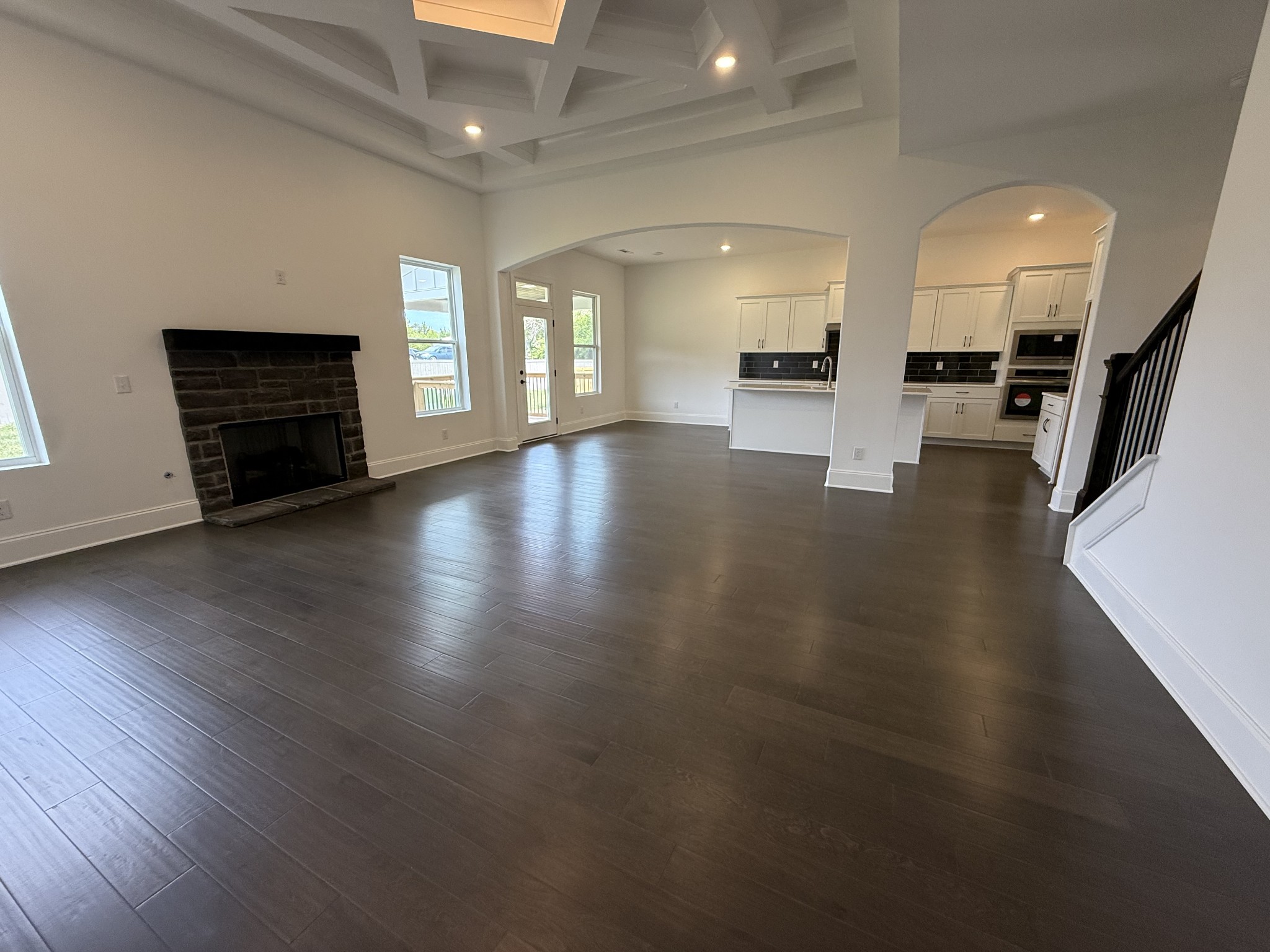2115 Harkreader Road Mount Juliet, TN 37122 - Photo 18 of 21 an empty room with wooden floor and a kitchen